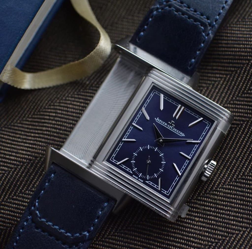 A Jaeger-LeCoultre Reverso with a blue dial, applied indices, and a navy strap