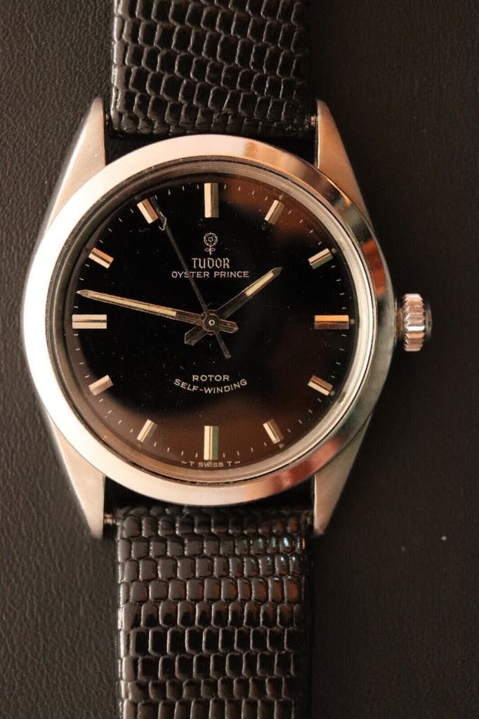A Tudor Oyster Prince with a black dial and applied indices on a textured strap